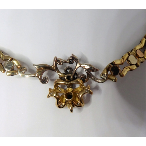 165 - a 14-carat yellow gold (marked '585', Italy) openwork neck chain with an integral flowerhead style p... 