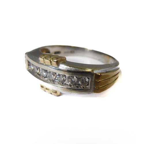 173 - A 9-carat gold ring set with seven diamonds, ring size T