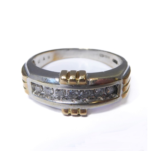 173 - A 9-carat gold ring set with seven diamonds, ring size T