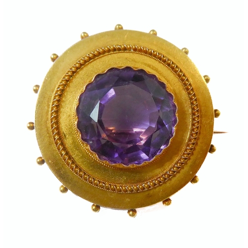 128 - A mid-19th century amethyst and yellow-gold brooch: the central circular mixed-cut amethyst collet-s... 