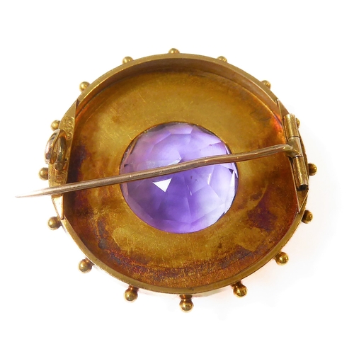 128 - A mid-19th century amethyst and yellow-gold brooch: the central circular mixed-cut amethyst collet-s... 