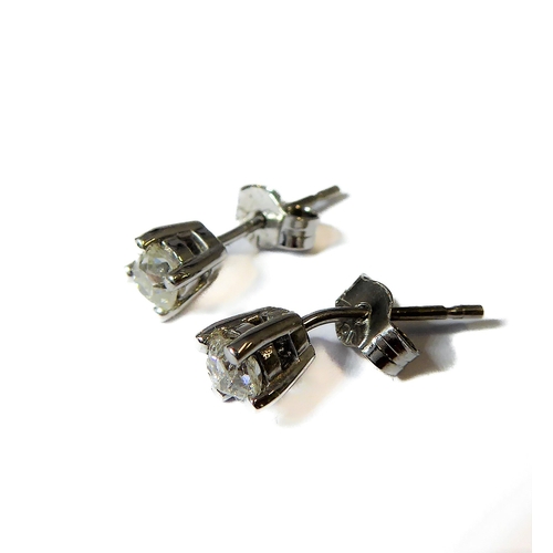 143 - A pair of 18-carat white gold ear studs, each set with a single old cut diamond, total diamond weigh... 