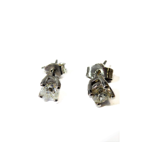 143 - A pair of 18-carat white gold ear studs, each set with a single old cut diamond, total diamond weigh... 
