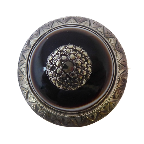 148 - An unusual 19th century Aesthetic style circular silver and hardstone-mounted brooch (boxed)