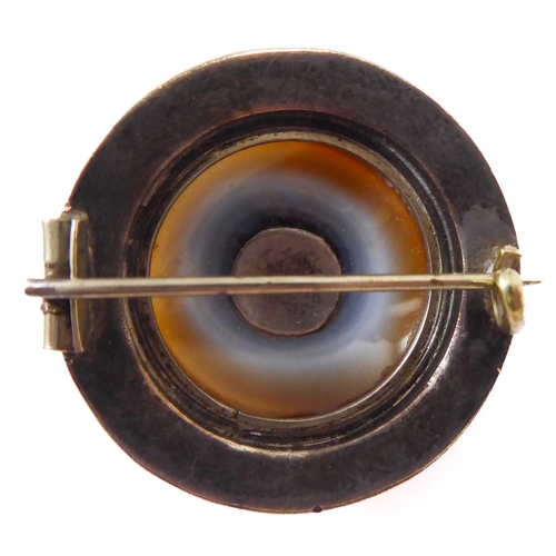 148 - An unusual 19th century Aesthetic style circular silver and hardstone-mounted brooch (boxed)