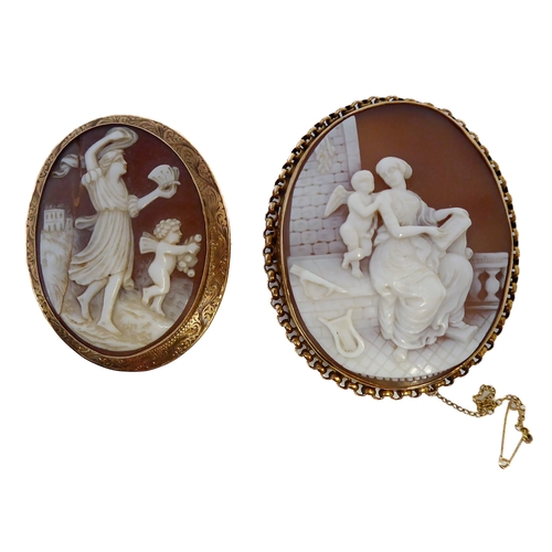 155 - Two oval shell cameo brooches: the first depicting a seated lady reading to Cupid within a collet an... 