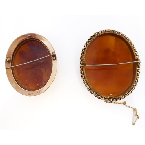 155 - Two oval shell cameo brooches: the first depicting a seated lady reading to Cupid within a collet an... 