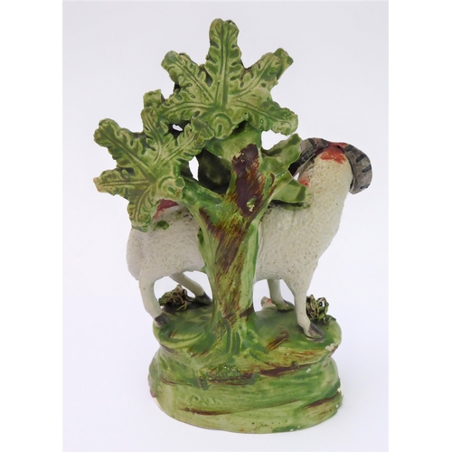 14 - Four early 19th century Staffordshire bocage figures: a ram and young stag, a recumbent stag and a r... 