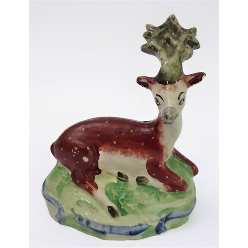 14 - Four early 19th century Staffordshire bocage figures: a ram and young stag, a recumbent stag and a r... 