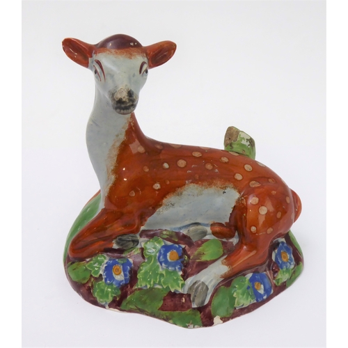 14 - Four early 19th century Staffordshire bocage figures: a ram and young stag, a recumbent stag and a r... 