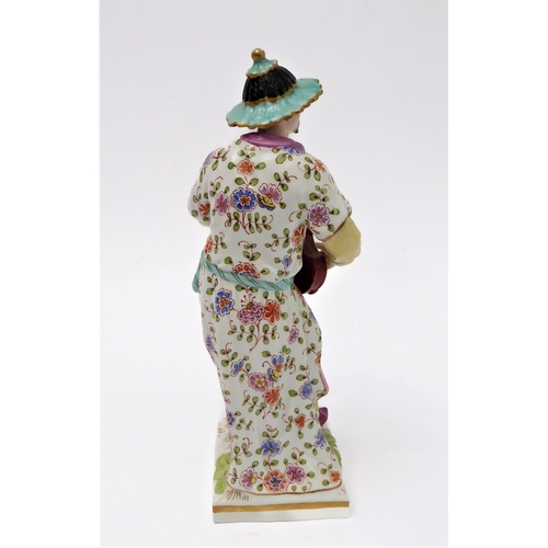 2 - An early 19th century hand-decorated porcelain figure model (probably Berlin) of a Chinese man playi... 