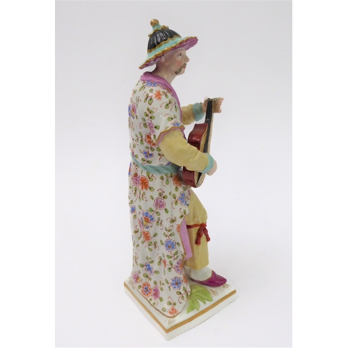 2 - An early 19th century hand-decorated porcelain figure model (probably Berlin) of a Chinese man playi... 