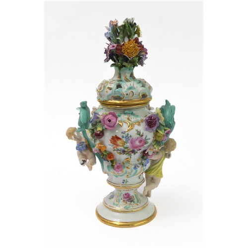 23 - A 19th century hand-decorated German porcelain potpourri: the reticulated dome-topped gilt highlight... 