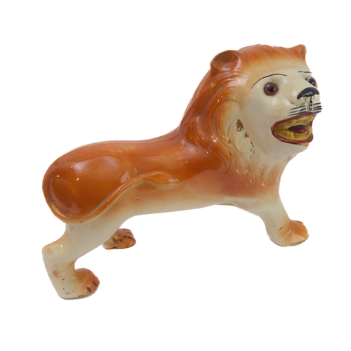 79 - A large opposing pair of late 19th century Staffordshire lions: each with glass eyes, open mouthed a... 