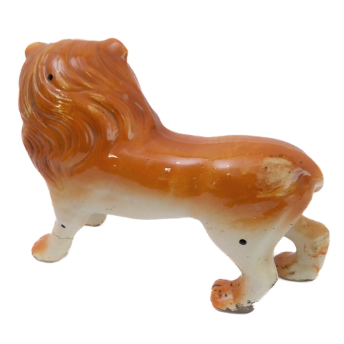 79 - A large opposing pair of late 19th century Staffordshire lions: each with glass eyes, open mouthed a... 