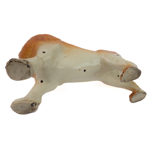 79 - A large opposing pair of late 19th century Staffordshire lions: each with glass eyes, open mouthed a... 