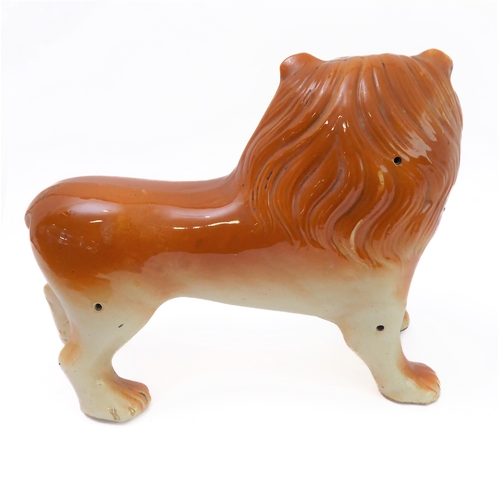 79 - A large opposing pair of late 19th century Staffordshire lions: each with glass eyes, open mouthed a... 