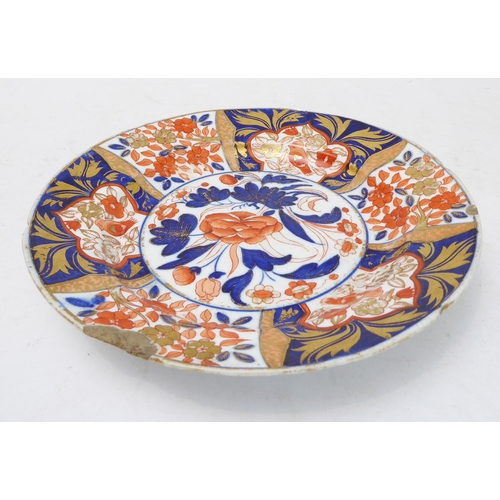 12 - Four ceramic pieces:
 1. An early 19th century fine English ceramic plate decorated in the Imari pal... 