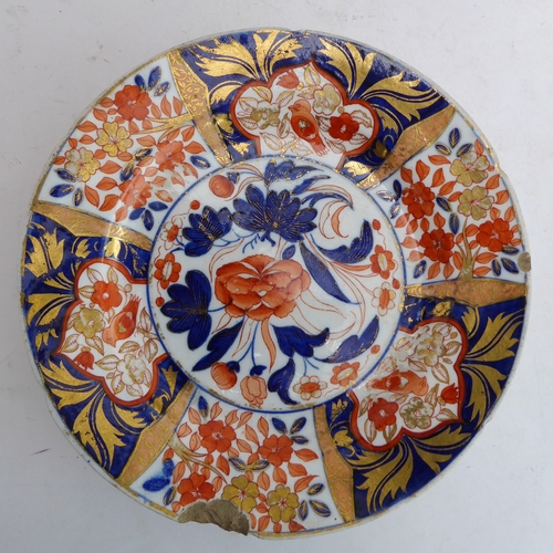 12 - Four ceramic pieces:
 1. An early 19th century fine English ceramic plate decorated in the Imari pal... 