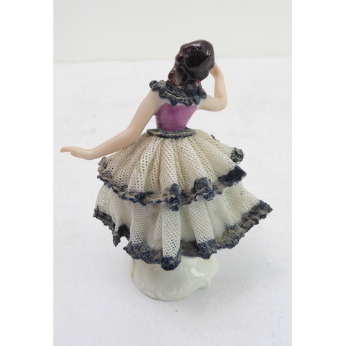 21 - A late 19th to early 20th century continental hand-decorated porcelain model of a lady dancing, toge... 