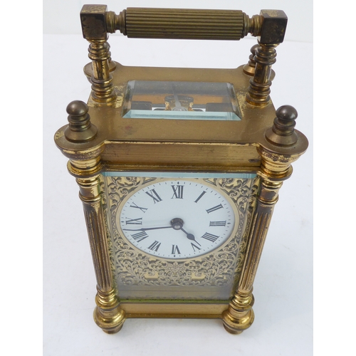 286 - An early 20th century gilt-metal and glass-sided carriage timepiece: white enamel dial with Roman nu... 