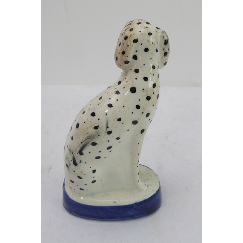 38 - A 19th century seated Staffordshire dalmatian (18 cm high)