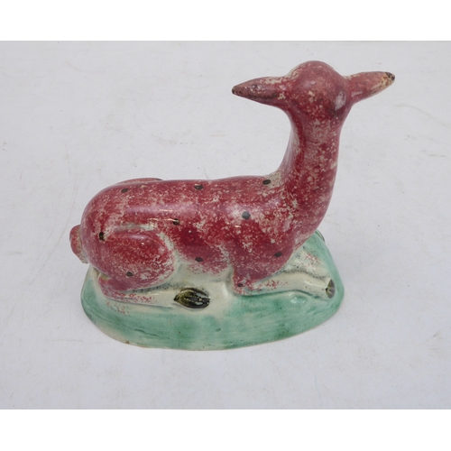 39 - A late 18th to early 19th century Staffordshire pearlware model of a recumbent deer (14 x 7.4 x 14 c... 