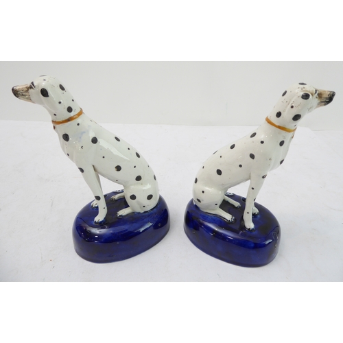 43 - A pair of 19th century Staffordshire inkwells modelled as seated Dalmatians (14.5 cm)