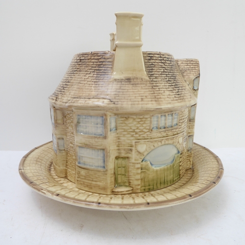 64 - A hand-decorated 'Bell Inn - 1642' ceramic Stilton plate and cover. The plate with text reading 'In ... 