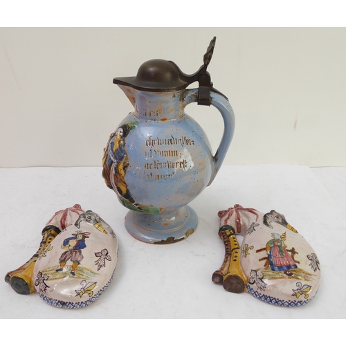 70 - A pair of Porquier-Beau Quimper faience wall-pockets and a glazed German stoneware flagon:
 1. The w... 