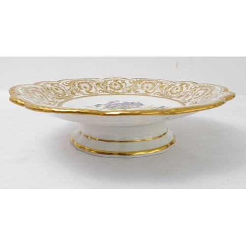 81 - A 19th century ceramic dessert comport: ornately scrolling gilded border surrounding a central vigne... 