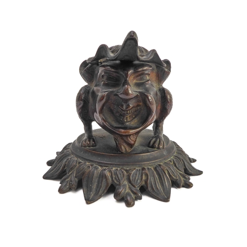 120 - A late 19th century bronze therianthrope inkwell in the form of a biped with human head and canine l... 
