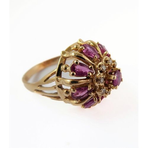 281 - A 14-carat gold bombé ring set with rubies and diamonds , ring size Q