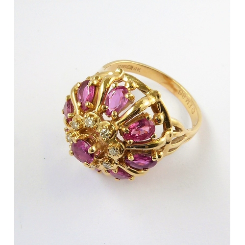 281 - A 14-carat gold bombé ring set with rubies and diamonds , ring size Q