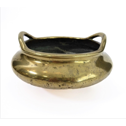 110 - A Chinese polished brass/bronze two-handled tripod censer in 17th century style: six character apocr... 