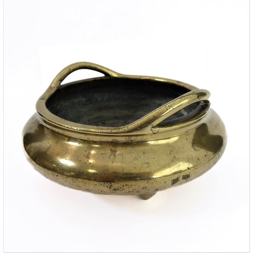 110 - A Chinese polished brass/bronze two-handled tripod censer in 17th century style: six character apocr... 
