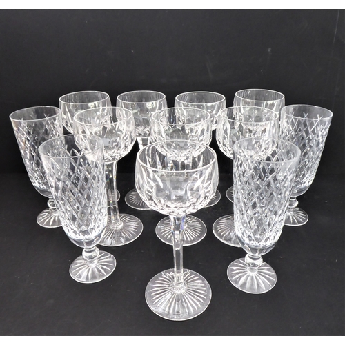 99 - A set of eight hand-cut hock glasses with star-cut bases, together with a set of four hand-cut flute... 