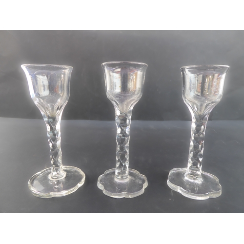 103 - Three 18th century George III handblown glass wine glasses with flared circular and cut ogee shaped ... 