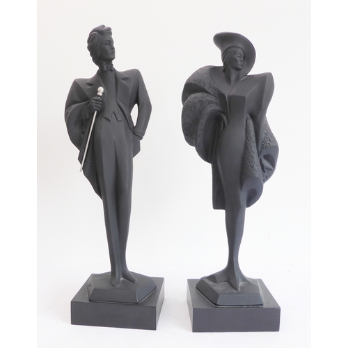 75 - A pair of Austin Productions Inc. black ceramic figures of a lady and gentleman, signed 