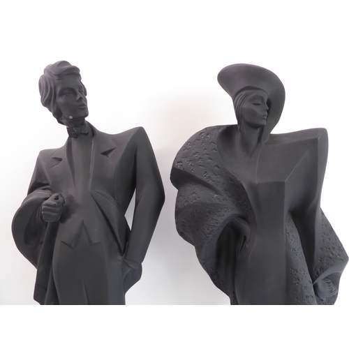 80 - A pair of Austin Productions Inc. black ceramic figures of a lady and gentleman, signed 