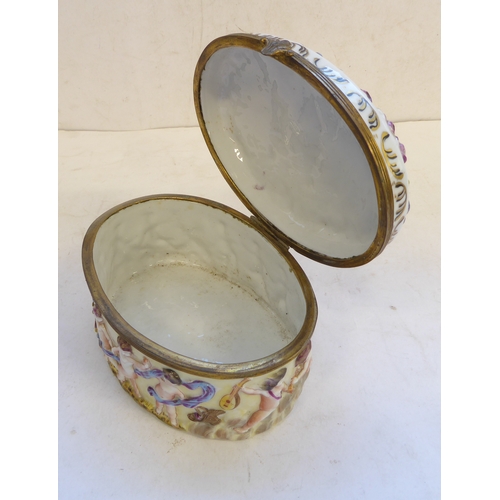 49 - A 19th century Italian Naples porcelain and gilt metal mounted oval casket. The hinged oval top deco... 