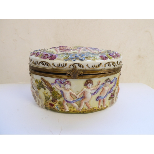 49 - A 19th century Italian Naples porcelain and gilt metal mounted oval casket. The hinged oval top deco... 