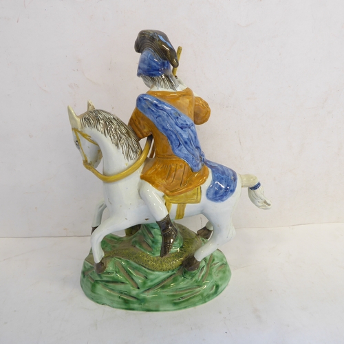 60 - A circa 1790 Staffordshire pottery figure of St. George and the Dragon. The figure of St. George, ho... 