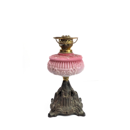 100 - A 19th century brass opaline glass and cast-iron oil lamp: the crimped-edge cranberry and opaline-st... 