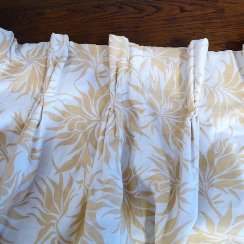 405 - A pair of curtains in a heavy cream linen-effect fabric with gold leaf pattern; triple pinch pleat h... 