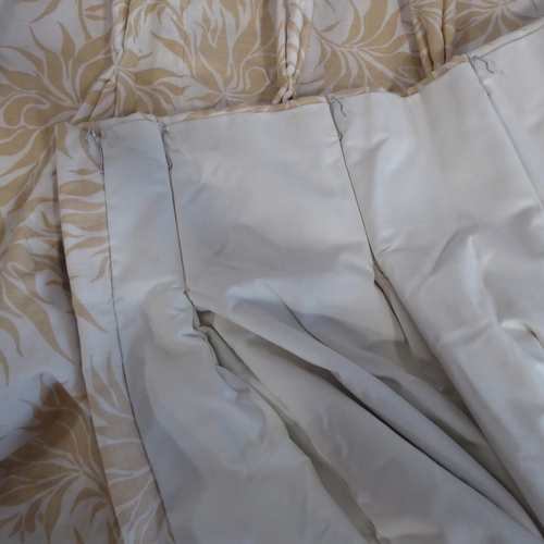 405 - A pair of curtains in a heavy cream linen-effect fabric with gold leaf pattern; triple pinch pleat h... 