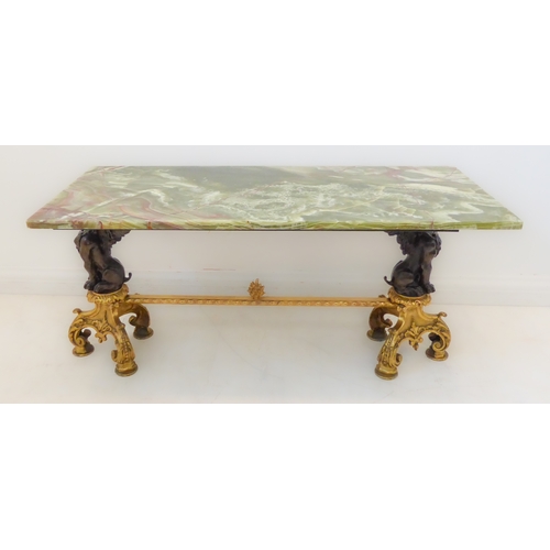 414 - A green onyx coffee table with cast base (probably ormolu and bronze): two supports as winged anthro... 