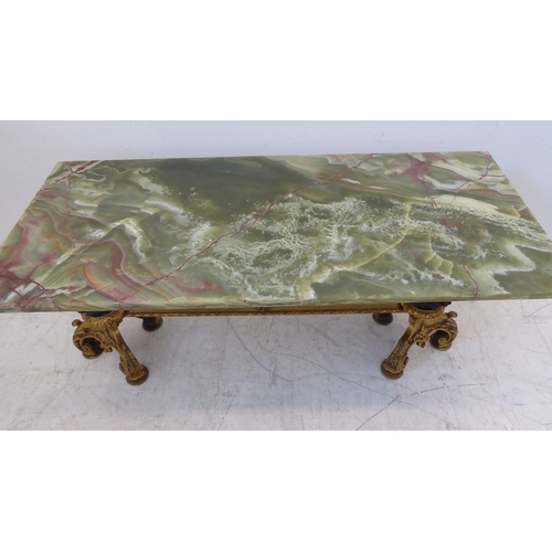 414 - A green onyx coffee table with cast base (probably ormolu and bronze): two supports as winged anthro... 