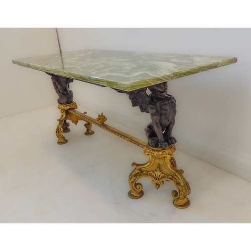 414 - A green onyx coffee table with cast base (probably ormolu and bronze): two supports as winged anthro... 