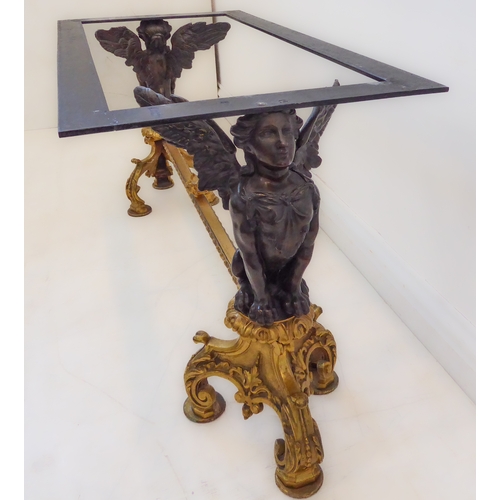 414 - A green onyx coffee table with cast base (probably ormolu and bronze): two supports as winged anthro... 